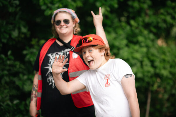 Two people waving to the camera